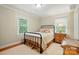 Cozy bedroom featuring natural light from two windows, hardwood floors, and neutral decor at 2025 Sagamore Rd, Charlotte, NC 28209