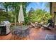Enjoy outdoor living on this deck with a grill, dining table and lounge area, perfect for entertaining or relaxing at 2025 Sagamore Rd, Charlotte, NC 28209