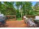 Wooden deck with outdoor furniture, a grill, and a view of the landscaped yard at 2025 Sagamore Rd, Charlotte, NC 28209