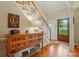 Foyer with hardwood floors, staircase, wooden accent table, and natural light at 2025 Sagamore Rd, Charlotte, NC 28209