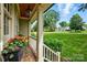 View from covered porch showing landscaped front yard and neighborhood at 2025 Sagamore Rd, Charlotte, NC 28209