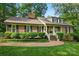 Beautifully landscaped front yard leading to a brick home with inviting front porch at 2025 Sagamore Rd, Charlotte, NC 28209
