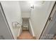 Staircase descending down to the basement with carpeted steps and white trim at 2025 Sagamore Rd, Charlotte, NC 28209
