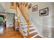 Beautiful staircase with wooden steps and white railings, leading to the upper level at 2025 Sagamore Rd, Charlotte, NC 28209