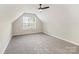 This bedroom has neutral walls, carpet, and a dormer window at 204 Pebble Creek Xing, Fort Mill, SC 29715