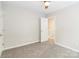 Comfortable bedroom with a ceiling fan, neutral paint, and an entry door at 204 Pebble Creek Xing, Fort Mill, SC 29715