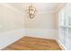 Dining room with decorative light fixture, crown molding, wainscoting, and large window at 204 Pebble Creek Xing, Fort Mill, SC 29715