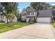 Charming two-story home with a manicured lawn and long driveway at 204 Pebble Creek Xing, Fort Mill, SC 29715