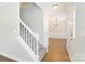 Bright foyer with a stairway, hardwood floors and chandelier-style lighting leading into the living space at 204 Pebble Creek Xing, Fort Mill, SC 29715