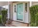 Charming home with an inviting light blue front door with sidelights and decorative floral arrangements at the entrance at 204 Pebble Creek Xing, Fort Mill, SC 29715