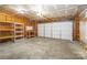Unfinished garage space showing the door, shelving and utilities at 204 Pebble Creek Xing, Fort Mill, SC 29715