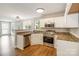 Traditional style kitchen featuring stainless steel appliances, granite countertops, and sleek white cabinets at 204 Pebble Creek Xing, Fort Mill, SC 29715