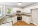 Updated kitchen featuring granite countertops, stainless steel appliances, and natural light at 204 Pebble Creek Xing, Fort Mill, SC 29715