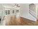 A spacious living room area featuring hardwood floors, a fireplace, and natural light from large windows at 204 Pebble Creek Xing, Fort Mill, SC 29715