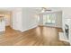 Spacious living room with hardwood floors, a fireplace, large windows for natural light, and an open layout at 204 Pebble Creek Xing, Fort Mill, SC 29715
