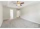 Neutral primary bedroom features a ceiling fan and an ensuite bathroom with a convenient entry door at 204 Pebble Creek Xing, Fort Mill, SC 29715
