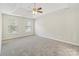 Spacious primary bedroom with neutral walls, a tray ceiling, fan, and two large sunny windows at 204 Pebble Creek Xing, Fort Mill, SC 29715
