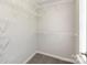 Large walk-in closet features an abundance of easily accessible built-in white wire shelving at 204 Pebble Creek Xing, Fort Mill, SC 29715