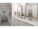 Bright bathroom featuring double sinks, quartz countertops, and walk-in shower at 2066 Skyhawk Dr, York, SC 29745