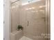 Modern walk-in shower with elegant tile work, a built-in bench, and a glass door at 2066 Skyhawk Dr, York, SC 29745