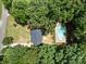 Aerial view showcases home and outdoor pool surrounded by mature trees at 219 Proctor Dr, Salisbury, NC 28147