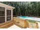 View from a wooden deck looking onto the backyard and a sparkling swimming pool at 219 Proctor Dr, Salisbury, NC 28147