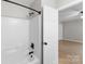 Bright bathroom featuring a shower-tub combo and white door leading to another room at 219 Proctor Dr, Salisbury, NC 28147