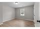 Bright bedroom featuring wood-look floors and a window with natural light at 219 Proctor Dr, Salisbury, NC 28147