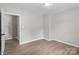 Neutral room featuring wood-look flooring, light fixtures, and neutral walls at 219 Proctor Dr, Salisbury, NC 28147