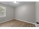 This bedroom has wood-look floors, a neutral color palette, and a window for natural light at 219 Proctor Dr, Salisbury, NC 28147