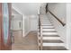Bright foyer showcasing hardwood floors, a staircase with wood railing, and an inviting entrance to the living area at 219 Proctor Dr, Salisbury, NC 28147