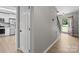 Hallway view with wood-look floors, leading to the kitchen featuring stainless steel appliances at 219 Proctor Dr, Salisbury, NC 28147