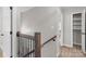 Upstairs hallway leads to bedrooms and bathrooms with a wooden staircase at 219 Proctor Dr, Salisbury, NC 28147