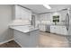 Spacious kitchen boasts granite countertops, stainless steel appliances, and bright white cabinets, with modern flooring at 219 Proctor Dr, Salisbury, NC 28147