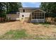 Back of the house with wooden deck and screened-in porch overlooking backyard at 219 Proctor Dr, Salisbury, NC 28147