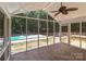 Cozy screened-in porch offers a view of the pool, yard, and outdoor deck at 219 Proctor Dr, Salisbury, NC 28147