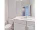 Bright bathroom features white cabinet vanity, toilet, and light tiled floor at 226 Gilead Rd, Huntersville, NC 28078
