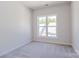 Bright bedroom showcasing bright window, neutral carpet, and closet at 226 Gilead Rd, Huntersville, NC 28078