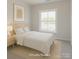 Staged bedroom showcasing bright window, neutral decor, and closet at 226 Gilead Rd, Huntersville, NC 28078
