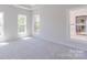 Bright bedroom featuring neutral carpet, three bright windows and light colored walls at 226 Gilead Rd, Huntersville, NC 28078