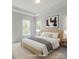 Staged main bedroom featuring tray ceilings, modern decor, and bright windows at 226 Gilead Rd, Huntersville, NC 28078