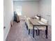 Dining room features a modern table with cream colored leather chairs and carpeted flooring at 230 Mountain Island Dr # 39, Statesville, NC 28677