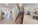 Inviting entryway with stairs leading up, view into kitchen and light colored flooring at 230 Mountain Island Dr # 39, Statesville, NC 28677