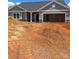 New home featuring gray siding, a two-car garage, and a covered front entrance at 230 Mountain Island Dr # 39, Statesville, NC 28677