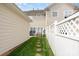 Narrow backyard with green grass, stepping stones, and white privacy fence at 2324 Bonterra Blvd, Indian Trail, NC 28079