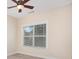 A serene bedroom featuring plush carpet, a ceiling fan, and a window with bright natural light at 2324 Bonterra Blvd, Indian Trail, NC 28079