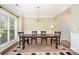 Formal dining area with wood floors, a chandelier, and a large window at 2324 Bonterra Blvd, Indian Trail, NC 28079