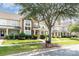 View of townhomes showcasing well-kept lawns, mature trees, and sidewalk at 2324 Bonterra Blvd, Indian Trail, NC 28079