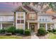 Charming townhome with stone accents, manicured landscaping, and welcoming front entrance at 2324 Bonterra Blvd, Indian Trail, NC 28079