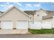 Two-car garage with white doors and siding, positioned behind the townhome at 2324 Bonterra Blvd, Indian Trail, NC 28079